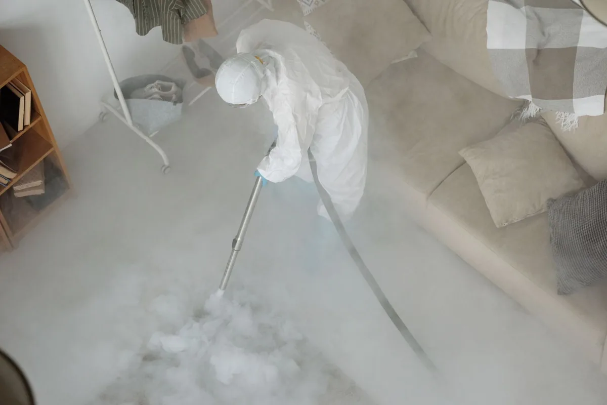 Biohazard cleanup technician in protective equipment, Oxoboxo River, CT